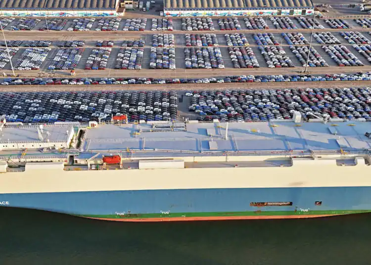 YANTAI, CHINA - MARCH 30: Aerial view of vehicles waiting to be loaded onto a ro-ro ship for export at Yantai Port on March 30, 2025 in Yantai, Shandong Province of China. (Photo by Sun Wentan/VCG via Getty Images)